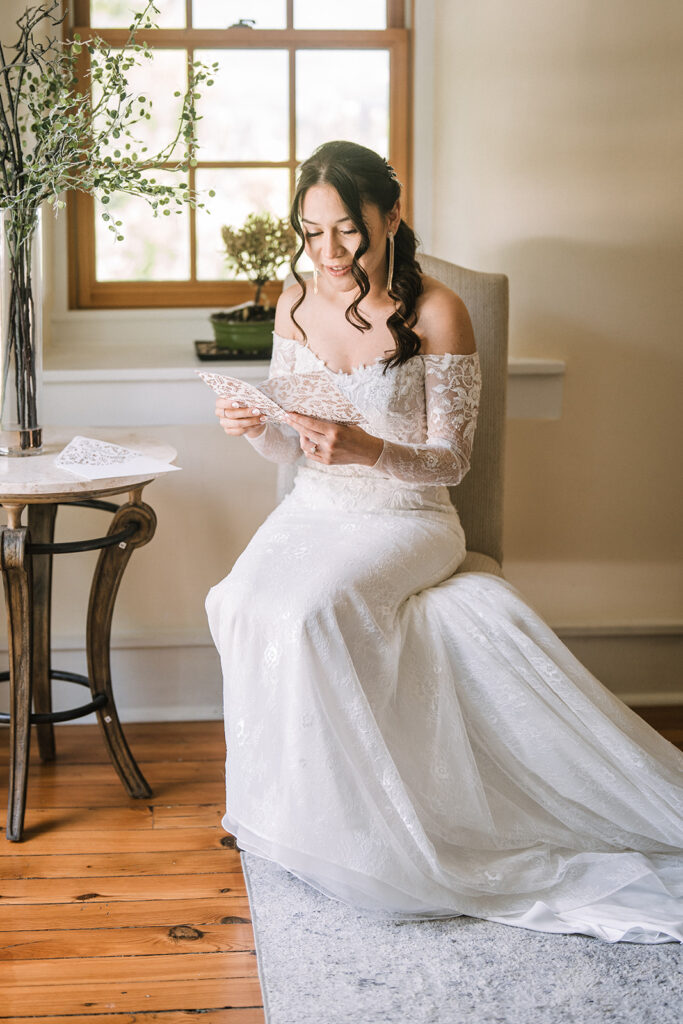 Bride reading letter from groom on wedding mornign