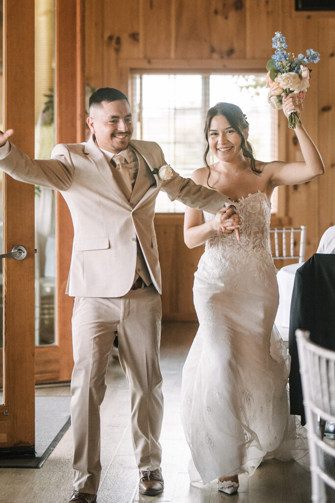 Bride and groom entering reception